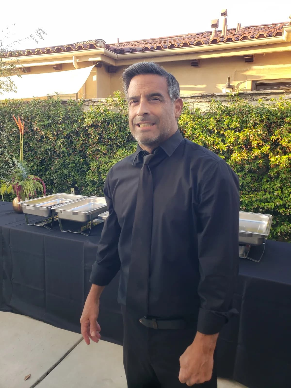Professional SoCal Bartender server in black attire at an outdoor catered event